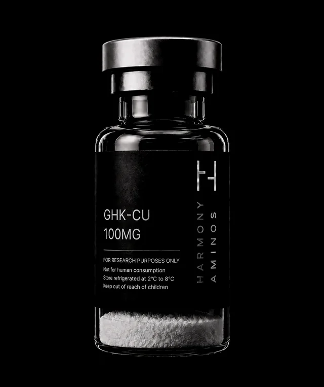 Harmony Aminos GHK-Cu 100 mg vial, lyophilised powder in clear glass with a black label and silver crimp cap.